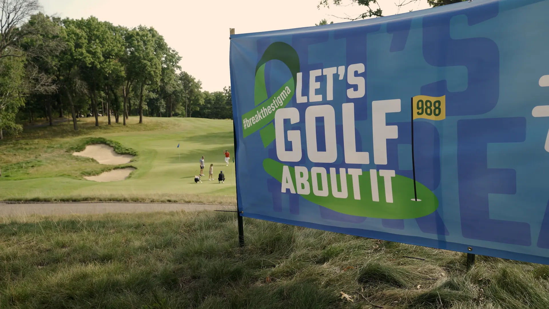 Let’s Golf About It banner overlooking the course
