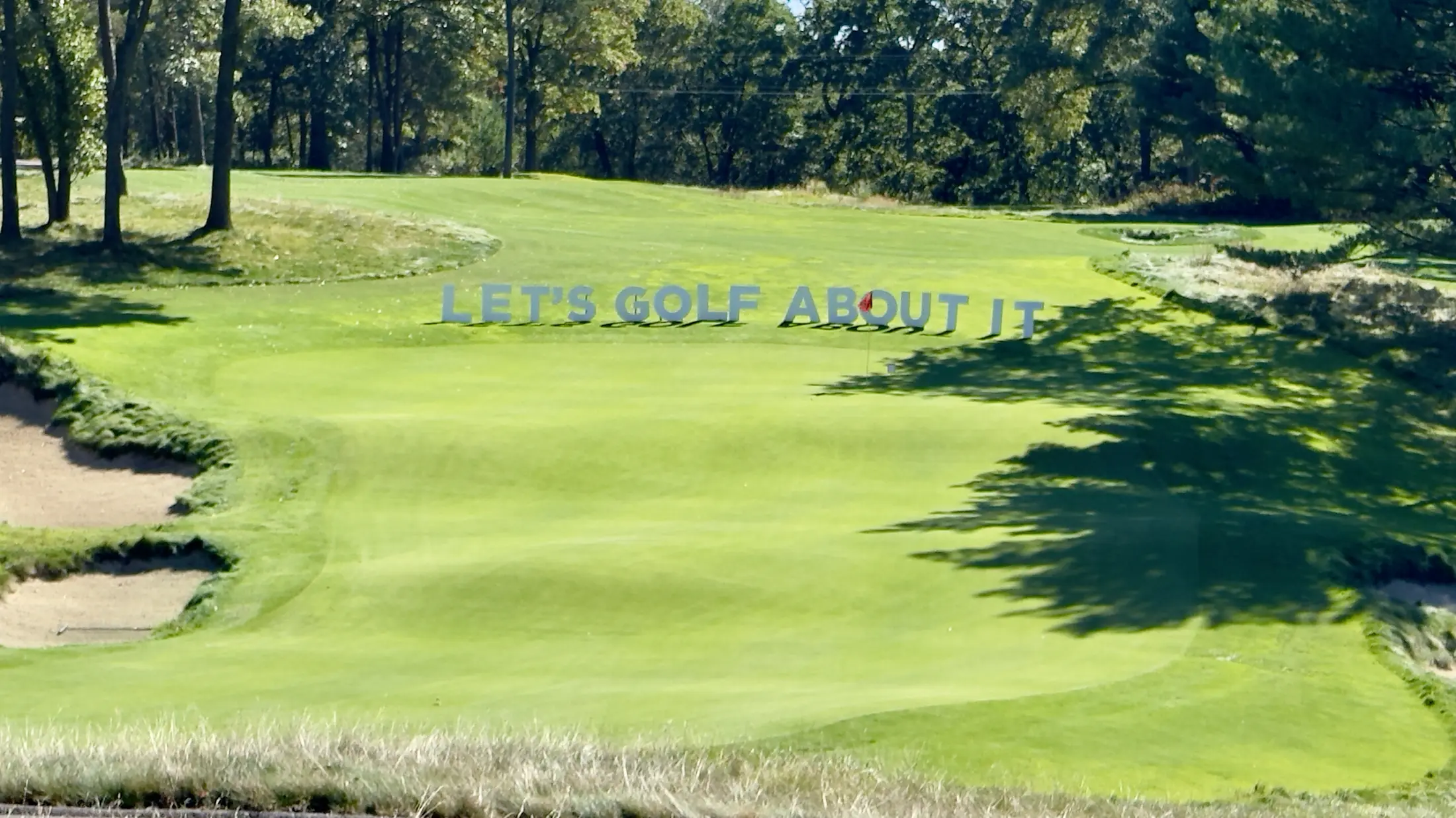 Let’s Golf About It letters displayed across the green
